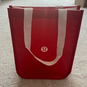 Classic red lululemon shopping bag with white strap